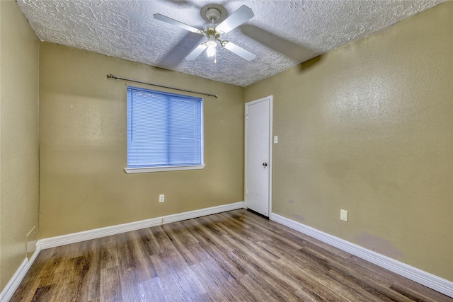 unfurnished room with a ceiling fan, wood finished floors, baseboards, and a textured ceiling