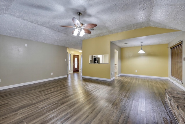 unfurnished living room with a ceiling fan, wood finished floors, baseboards, lofted ceiling, and a textured ceiling