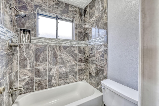 full bathroom featuring toilet, shower / bathing tub combination, and a textured wall