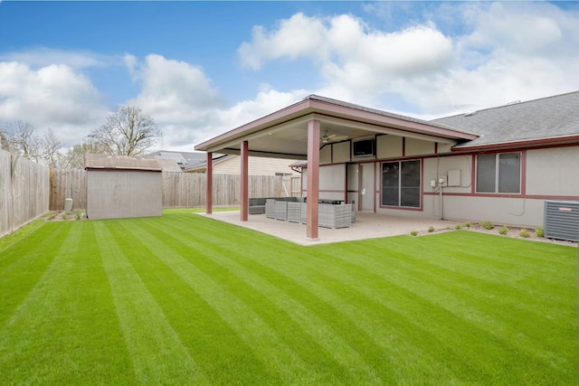 view of yard featuring outdoor lounge area, a patio, a fenced backyard, and an outdoor structure