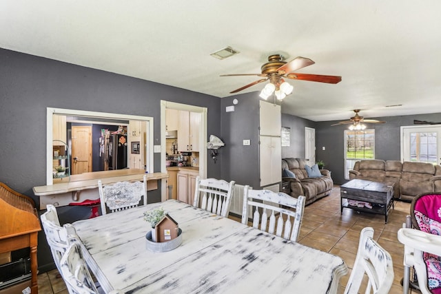 dining area featuring tile patterned flooring and visible vents