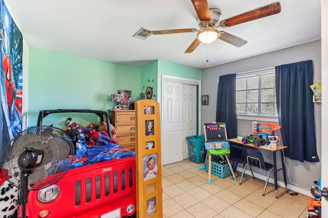 bedroom with visible vents, a closet, tile patterned flooring, baseboards, and ceiling fan