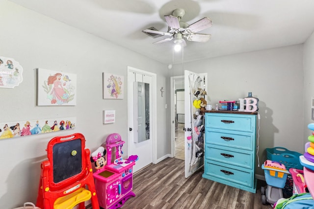 playroom featuring ceiling fan and dark wood finished floors