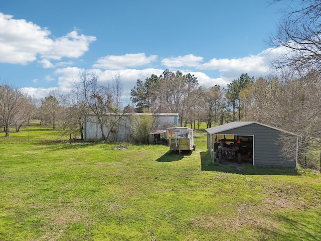 view of yard with an outbuilding, driveway, and a garage