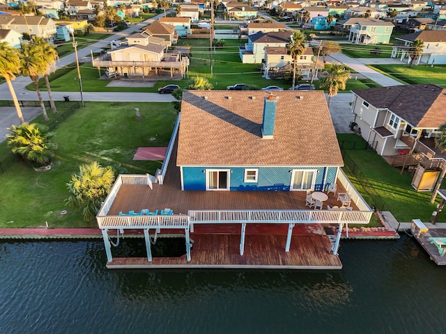 bird's eye view featuring a residential view and a water view