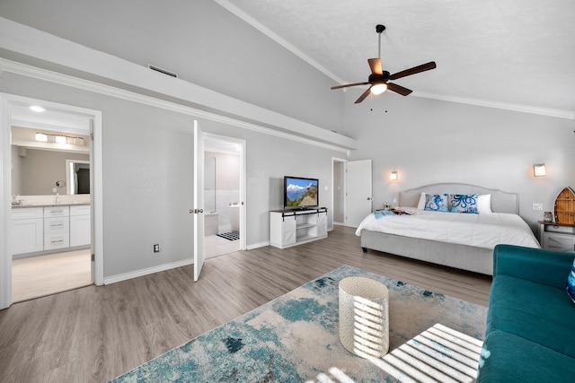 bedroom with connected bathroom, crown molding, baseboards, wood finished floors, and high vaulted ceiling