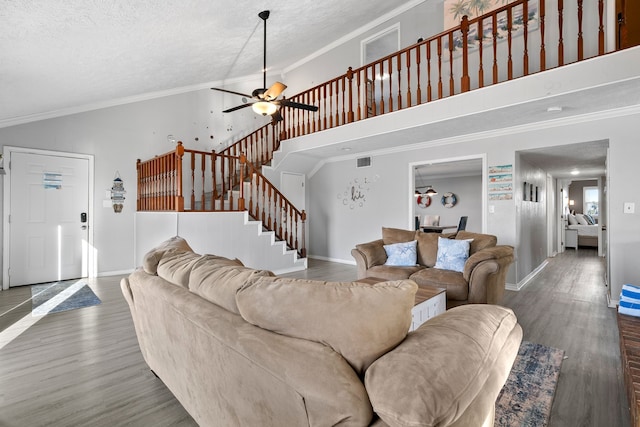 living room with visible vents, crown molding, stairs, and wood finished floors