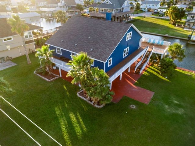 drone / aerial view with a residential view and a water view