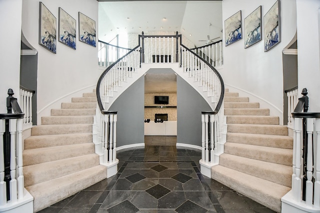 entrance foyer featuring stairway, recessed lighting, baseboards, and a towering ceiling