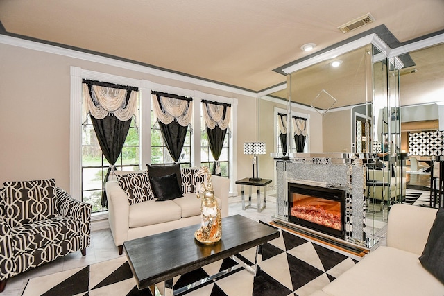 living area featuring a fireplace, visible vents, and ornamental molding