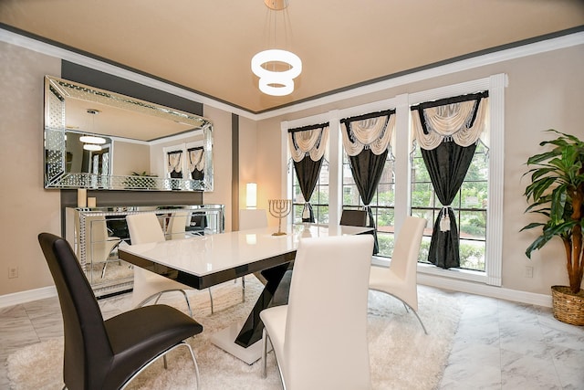 dining room with crown molding, baseboards, and marble finish floor