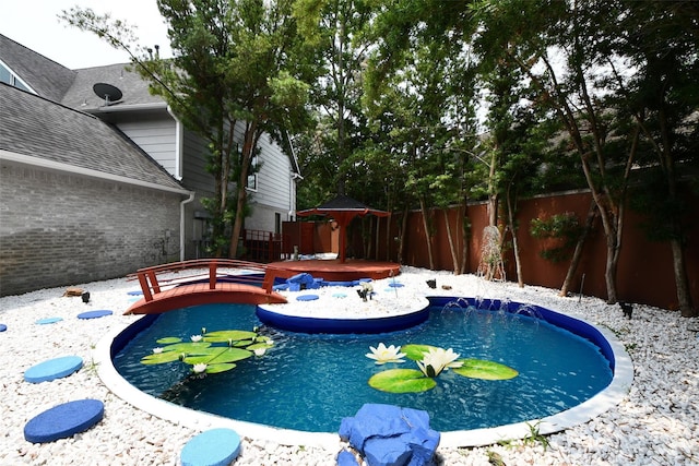 view of swimming pool with a deck, a fenced in pool, and a fenced backyard