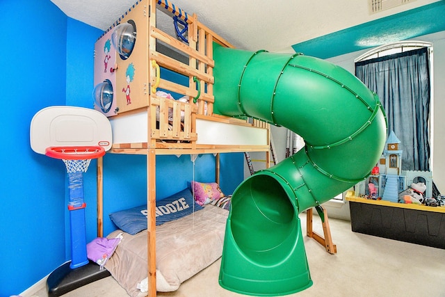 bedroom with visible vents, carpet flooring, and a textured ceiling