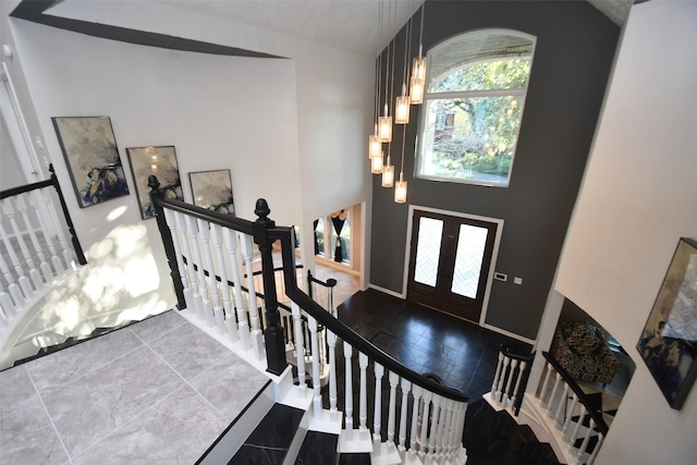 entryway with lofted ceiling and french doors