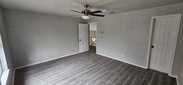 unfurnished room featuring ceiling fan, visible vents, baseboards, and dark wood-style floors