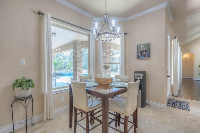 dining room featuring visible vents, baseboards, ornamental molding, an inviting chandelier, and arched walkways