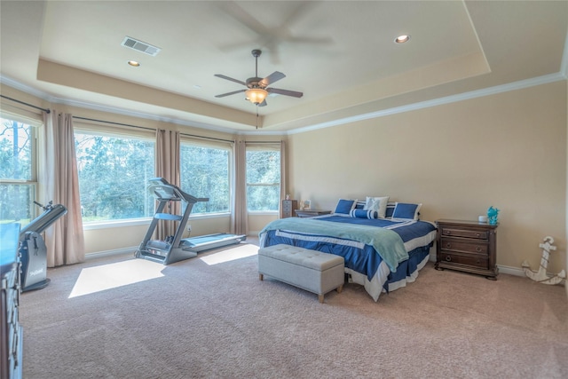 bedroom with visible vents, carpet flooring, crown molding, and a raised ceiling