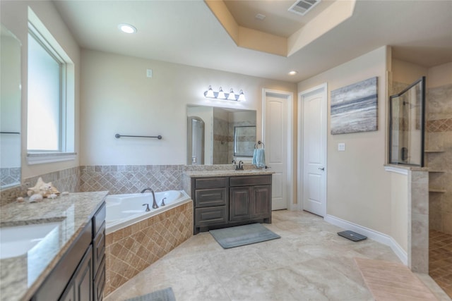 full bathroom featuring visible vents, two vanities, a tile shower, a sink, and a bath