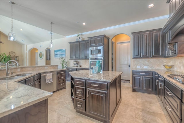 kitchen with a sink, a kitchen island, arched walkways, dark brown cabinetry, and appliances with stainless steel finishes