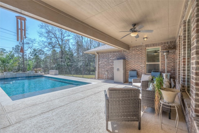 view of swimming pool featuring a fenced in pool, a patio, ceiling fan, and fence