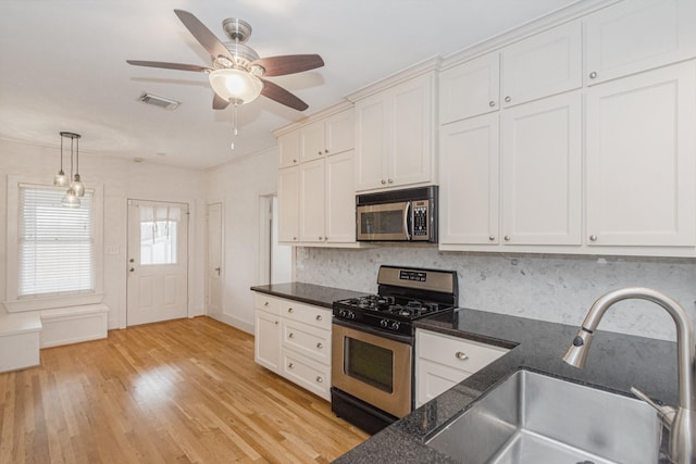 kitchen with visible vents, light wood-type flooring, a sink, white cabinetry, and appliances with stainless steel finishes