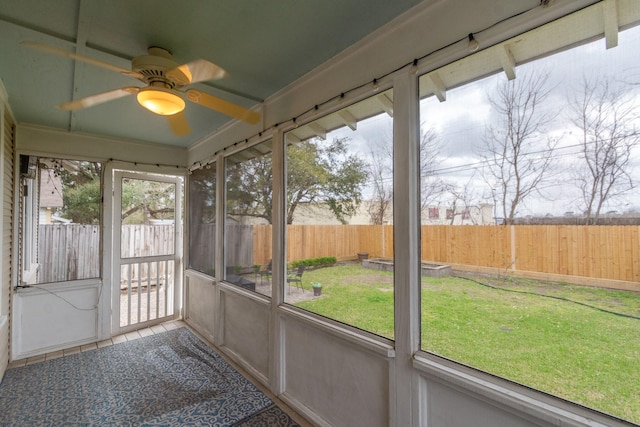 unfurnished sunroom with a ceiling fan