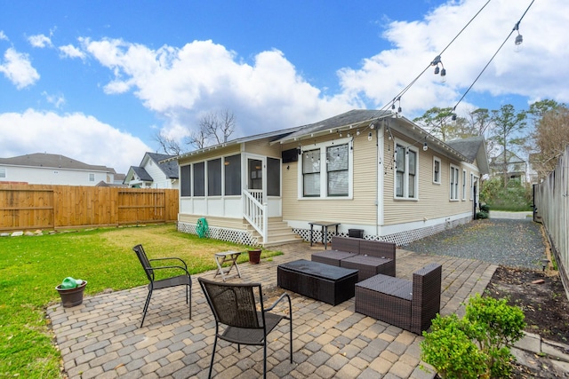 back of house featuring an outdoor living space, a fenced backyard, a sunroom, a patio area, and a lawn