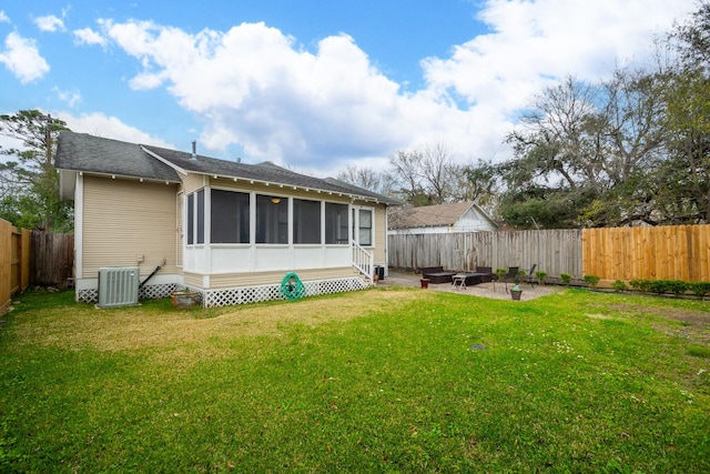 rear view of house featuring a patio, a lawn, central AC unit, and a fenced backyard