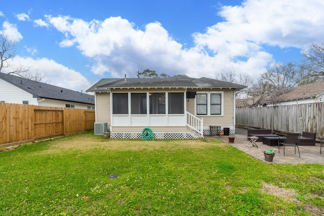 back of property featuring an outdoor fire pit, a fenced backyard, central air condition unit, a patio area, and a lawn