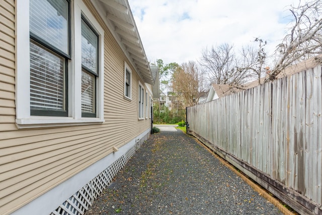 view of home's exterior featuring crawl space and fence