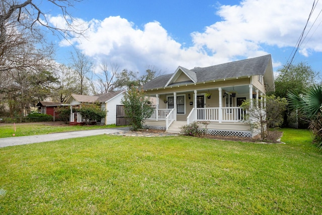 view of front of property with covered porch, concrete driveway, and a front lawn