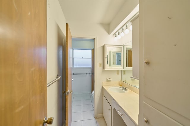 bathroom with vanity, toilet, and tile patterned flooring