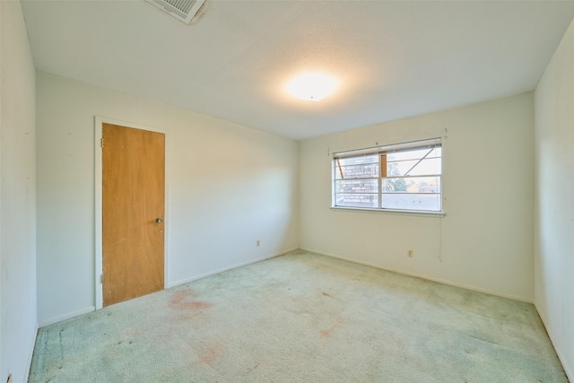 carpeted empty room with visible vents