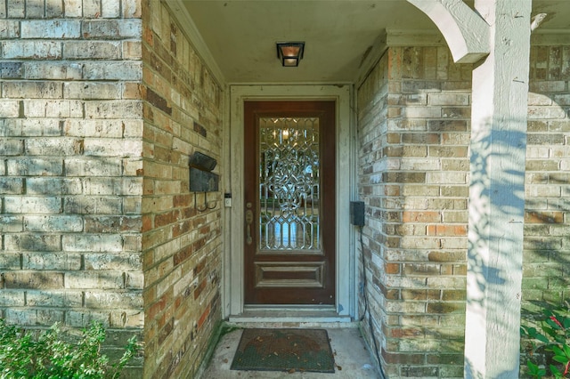 property entrance with brick siding