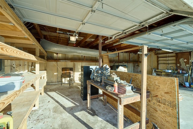 garage with a workshop area and a garage door opener