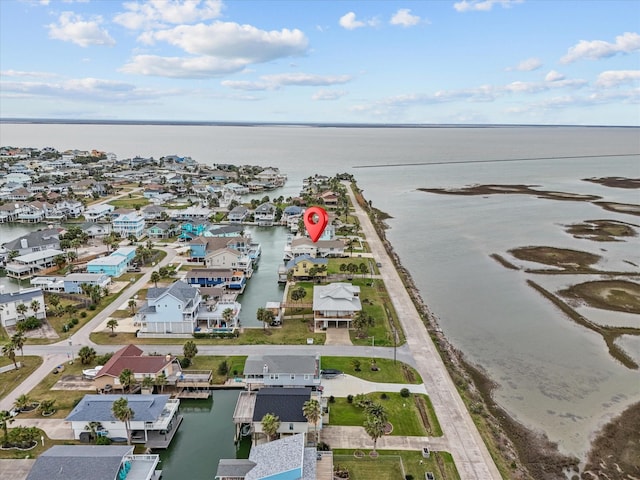 drone / aerial view with a residential view and a water view