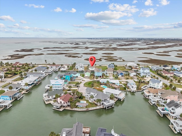 drone / aerial view featuring a water view and a residential view