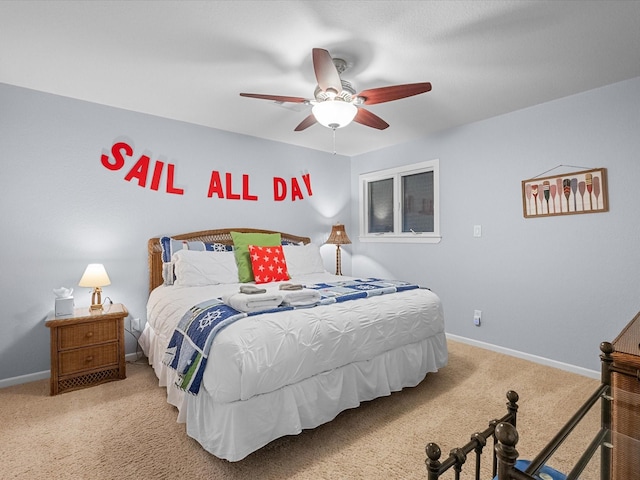 bedroom with a ceiling fan, baseboards, and carpet floors