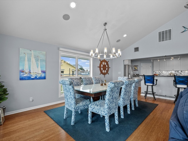 dining space with visible vents, baseboards, an inviting chandelier, and wood finished floors