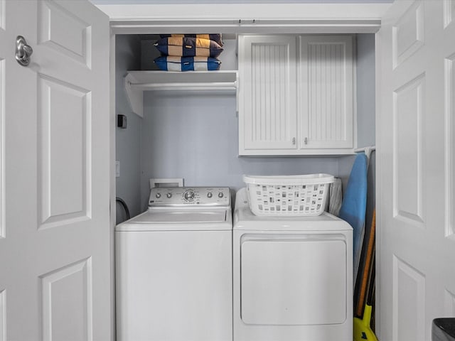 laundry area with cabinet space and independent washer and dryer