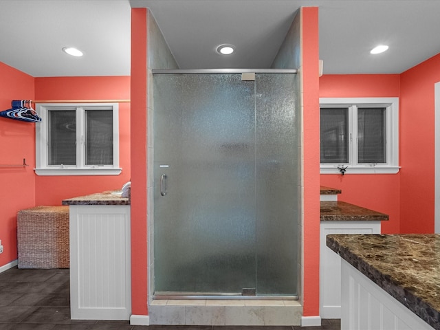 full bathroom featuring recessed lighting, a stall shower, vanity, and baseboards