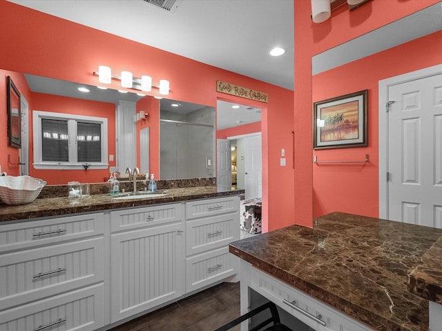 full bathroom with recessed lighting, a shower stall, vanity, and wood finished floors