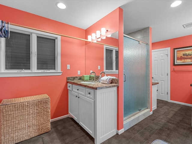 full bathroom featuring visible vents, recessed lighting, a shower stall, baseboards, and vanity