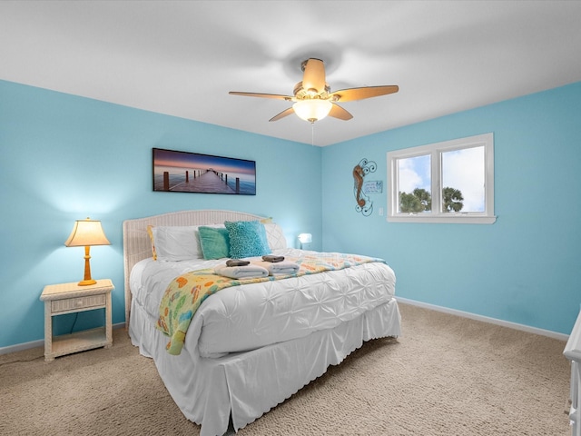 carpeted bedroom with baseboards and ceiling fan