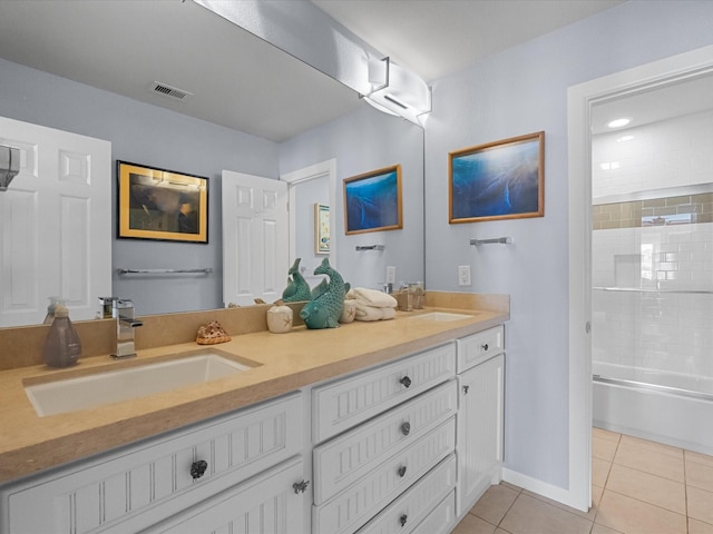 bathroom with tile patterned flooring, double vanity, visible vents, and a sink