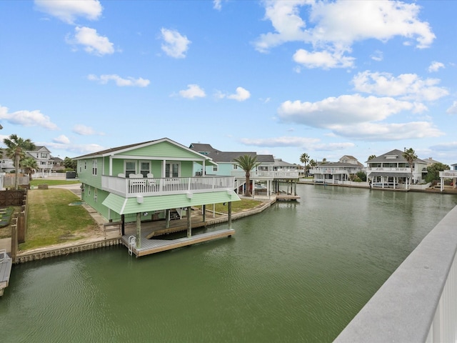 view of dock featuring a residential view and a water view