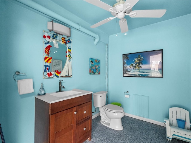 bathroom with toilet, vanity, baseboards, and ceiling fan