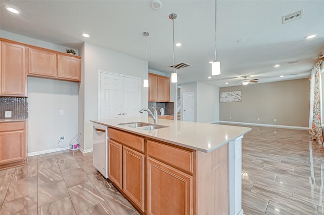 kitchen featuring tasteful backsplash, visible vents, white dishwasher, and a sink