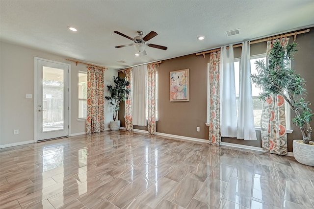 spare room featuring a ceiling fan, recessed lighting, baseboards, and visible vents