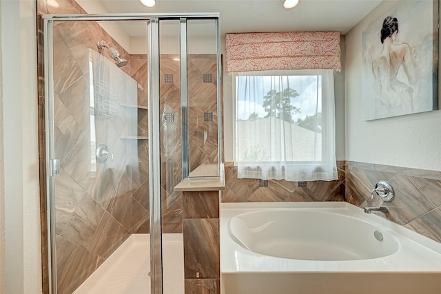 full bath featuring a garden tub and a shower stall